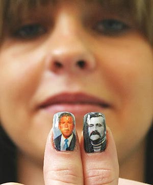 Woman has George Bush & Lech Walesa on her fingernails.